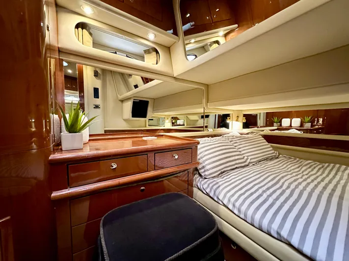Slim Smitty Yacht Photos Pics Luxurious cabin interior of 2002 Sea Ray 560 Sedan Bridge yacht with striped bedding.