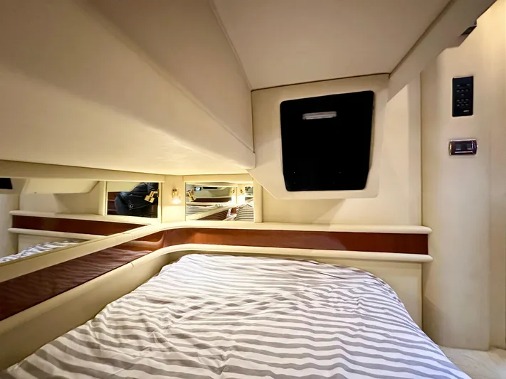 Slim Smitty Yacht Photos Pics Luxurious cabin interior of 2002 Sea Ray 560 Sedan Bridge yacht with striped bedding.