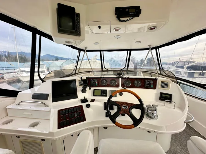 Slim Smitty Yacht Photos Pics Cockpit of 2002 Sea Ray 560 Sedan Bridge with navigation equipment and steering wheel.
