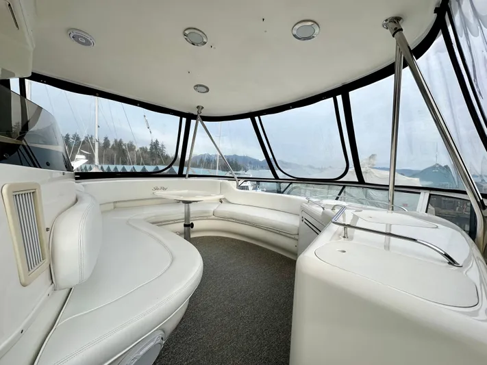 Slim Smitty Yacht Photos Pics Luxurious interior of 2002 Sea Ray 560 Sedan Bridge yacht with panoramic windows.