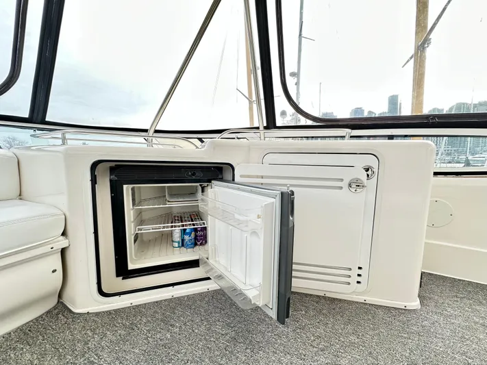 Slim Smitty Yacht Photos Pics Mini fridge on 2002 Sea Ray 560 Sedan Bridge yacht, open with drinks inside.
