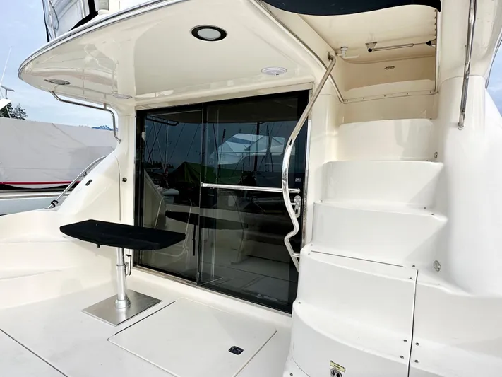 Slim Smitty Yacht Photos Pics 2002 Sea Ray 560 Sedan Bridge yacht with sleek exterior and elegant staircase.