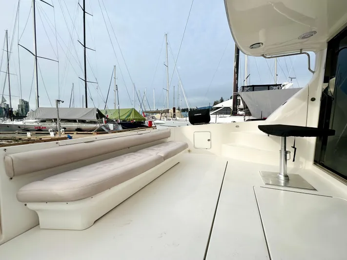 Slim Smitty Yacht Photos Pics 2002 Sea Ray 560 Sedan Bridge yacht deck with seating, docked at marina.