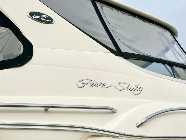 Slim Smitty Yacht Photos Pics 2002 Sea Ray 560 Sedan Bridge yacht, side view with "Five Sixty" lettering.