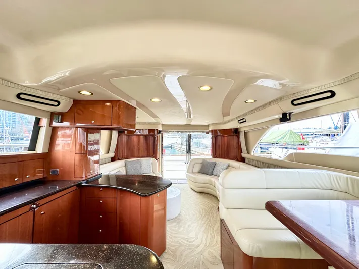 Slim Smitty Yacht Photos Pics Luxurious interior of 2002 Sea Ray 560 Sedan Bridge yacht with elegant wood and leather finishes.