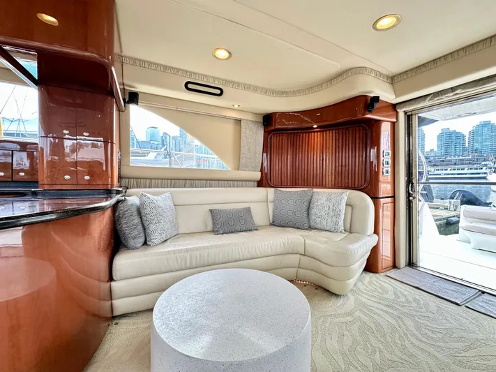 Slim Smitty Yacht Photos Pics Luxurious interior of 2002 Sea Ray 560 Sedan Bridge yacht with plush seating and city view.