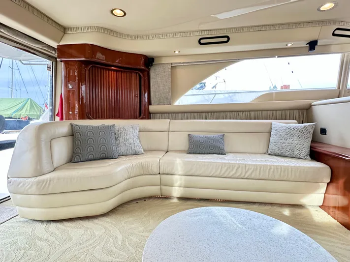 Slim Smitty Yacht Photos Pics Luxurious interior of 2002 Sea Ray 560 Sedan Bridge yacht with cream leather seating.