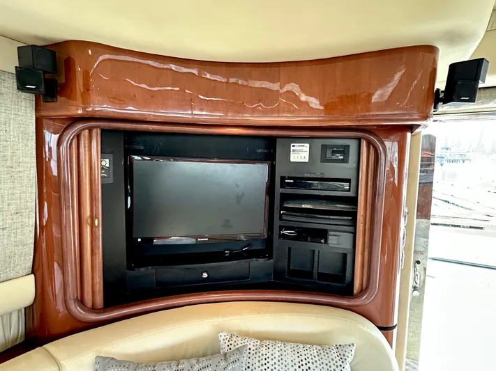 Slim Smitty Yacht Photos Pics Interior entertainment system on 2002 Sea Ray 560 Sedan Bridge yacht, featuring a TV and audio equipment.