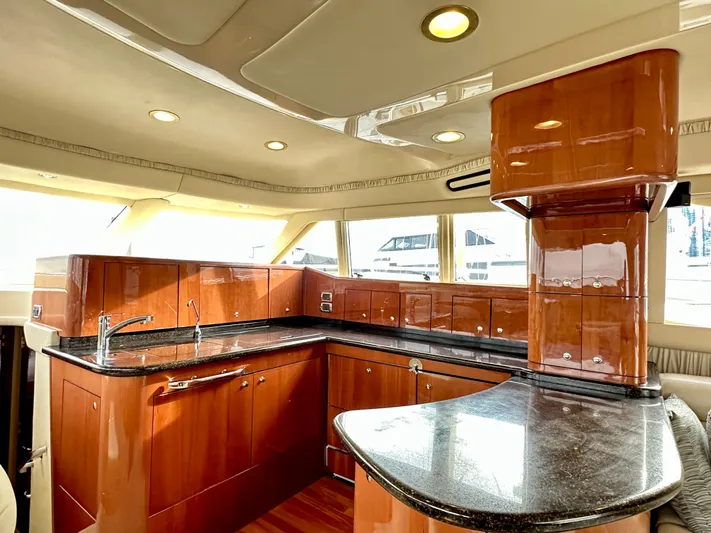 Slim Smitty Yacht Photos Pics Luxurious kitchen interior of 2002 Sea Ray 560 Sedan Bridge yacht with wood cabinetry.