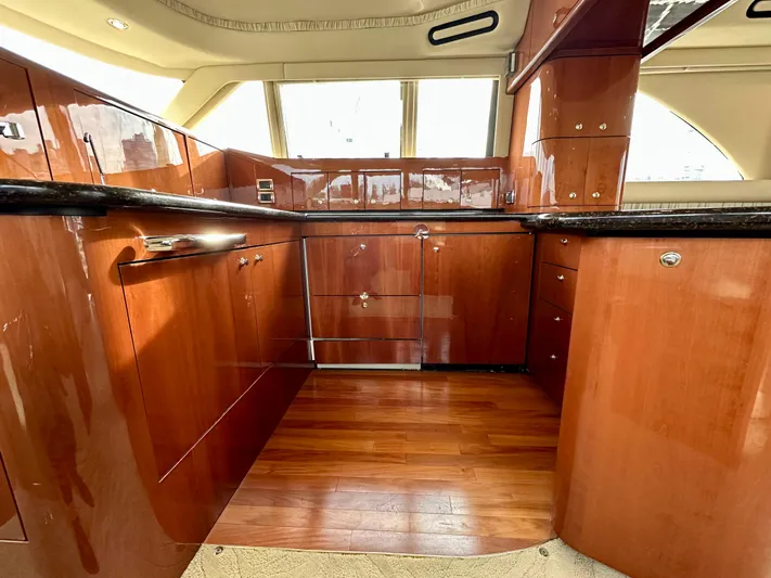 Slim Smitty Yacht Photos Pics Luxurious wooden interior of a 2002 Sea Ray 560 Sedan Bridge yacht kitchen.