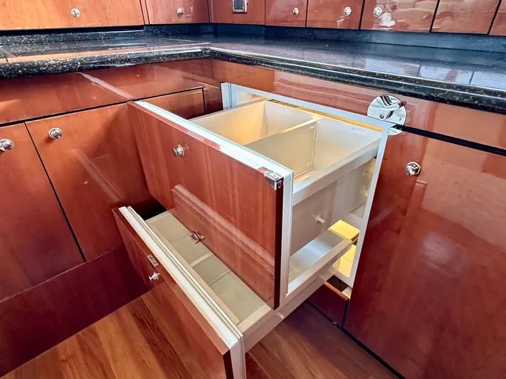 Slim Smitty Yacht Photos Pics Luxurious wooden cabinetry with open drawers in a 2002 Sea Ray 560 Sedan Bridge yacht.