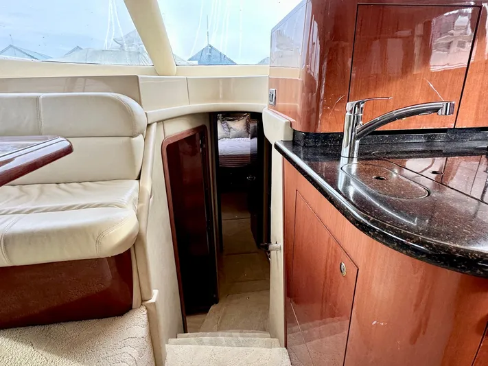 Slim Smitty Yacht Photos Pics Interior of 2002 Sea Ray 560 Sedan Bridge yacht with luxurious seating and kitchenette.