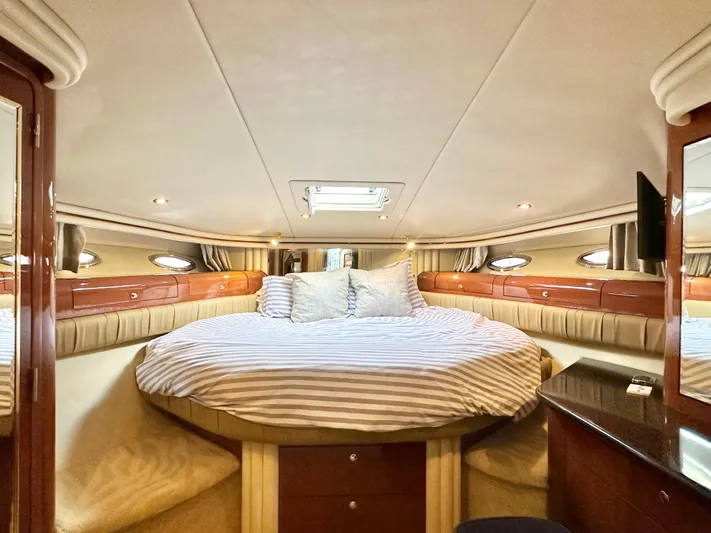 Slim Smitty Yacht Photos Pics Luxurious bedroom interior of 2002 Sea Ray 560 Sedan Bridge yacht with striped bedding.