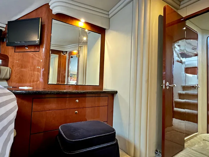 Slim Smitty Yacht Photos Pics Luxurious interior of 2002 Sea Ray 560 Sedan Bridge with wood cabinetry and mirror.