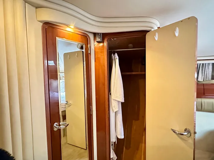 Slim Smitty Yacht Photos Pics Luxurious 2002 Sea Ray 560 Sedan Bridge interior with wooden closet and mirror.