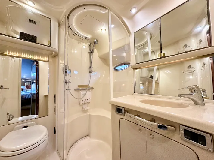 Slim Smitty Yacht Photos Pics Luxurious bathroom in 2002 Sea Ray 560 Sedan Bridge yacht with shower, sink, and toilet.