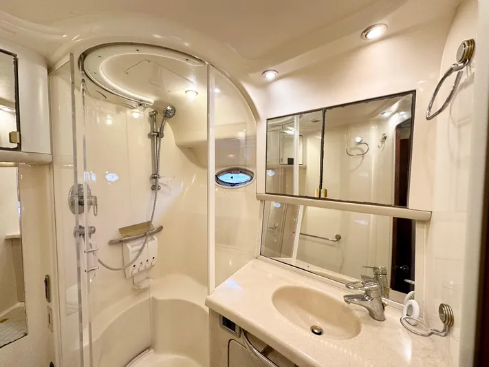 Slim Smitty Yacht Photos Pics Luxurious bathroom in 2002 Sea Ray 560 Sedan Bridge yacht with shower and vanity.