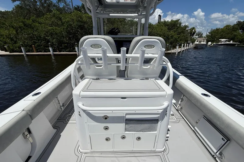  Yacht Photos Pics 2020 Sportsman Open 282 Center Console boat interior with seating and storage, docked by water.