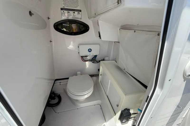  Yacht Photos Pics 2020 Sportsman Open 282 Center Console boat interior with toilet and storage.