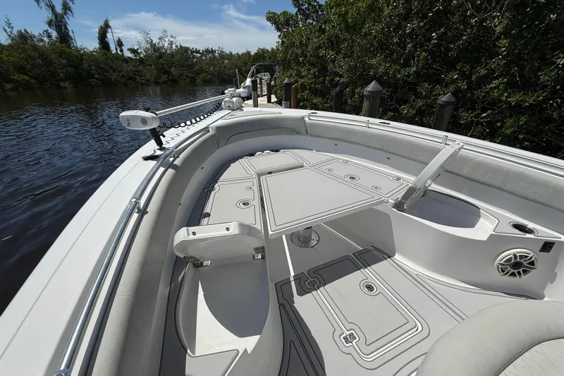  Yacht Photos Pics 2020 Sportsman Open 282 Center Console boat docked by lush greenery.