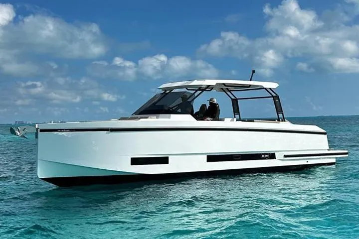 2025 Day 36 @ Cancun Yacht Photos Pics 2025 De Antonio Yachts D36 cruising on clear blue waters under a sunny sky.