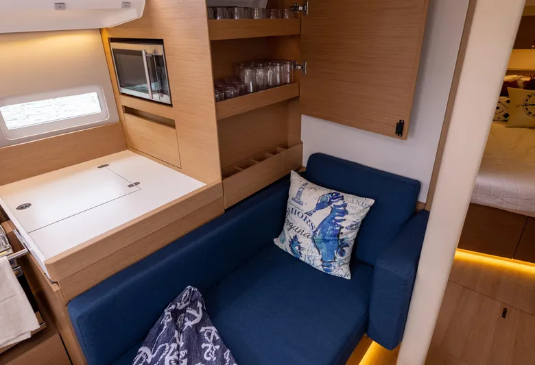 Yacht Photos Pics Interior of 2020 Jeanneau Sun Odyssey 410 yacht with blue sofa and modern kitchen.