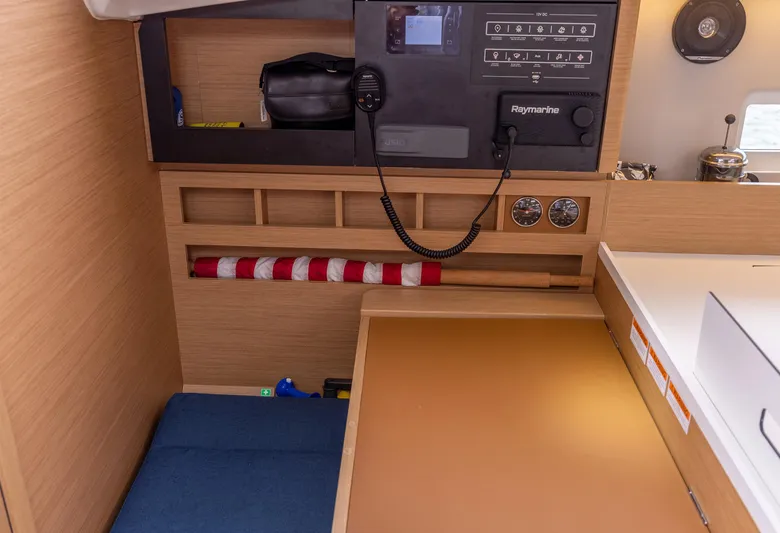  Yacht Photos Pics Navigation station of 2020 Jeanneau Sun Odyssey 410 sailboat with control panel and storage.
