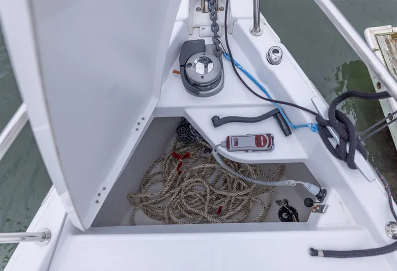  Yacht Photos Pics Open anchor locker on Jeanneau Sun Odyssey 410 sailboat, showing ropes and equipment.