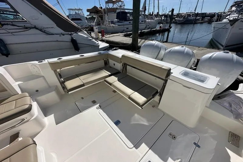 Wave Paver Yacht Photos Pics 2020 Pursuit OS 355 Offshore boat interior with seating, docked at marina.
