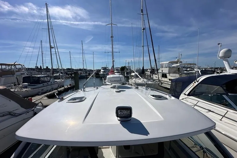 Wave Paver Yacht Photos Pics 2020 Pursuit OS 355 Offshore boat docked in a marina with clear skies.