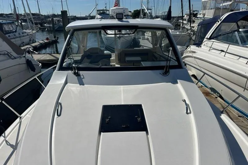 Wave Paver Yacht Photos Pics 2020 Pursuit OS 355 Offshore boat docked at a marina, surrounded by other vessels.