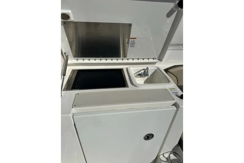 Wave Paver Yacht Photos Pics 2020 Pursuit OS 355 Offshore boat galley with sink and storage compartments.