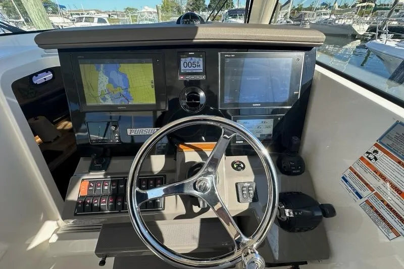 Wave Paver Yacht Photos Pics 2020 Pursuit OS 355 Offshore boat dashboard with navigation screens and controls.