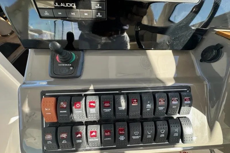 Wave Paver Yacht Photos Pics Control panel of a 2020 Pursuit OS 355 Offshore boat with switches and audio system.