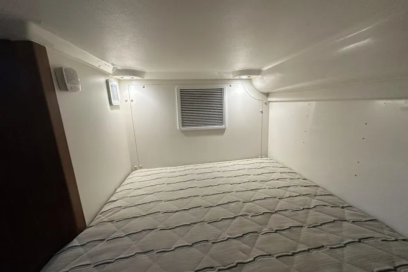 Wave Paver Yacht Photos Pics 2020 Pursuit OS 355 Offshore cabin interior with bed and ventilation.