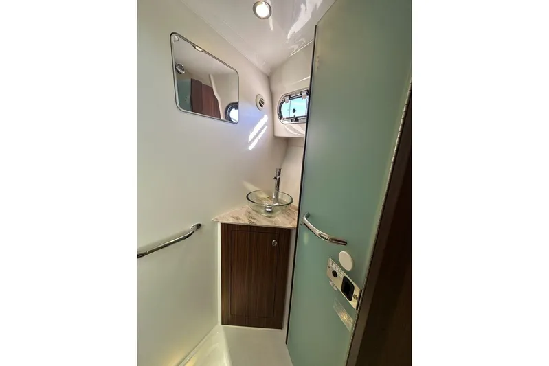 Wave Paver Yacht Photos Pics 2020 Pursuit OS 355 Offshore boat bathroom with modern sink and mirror.