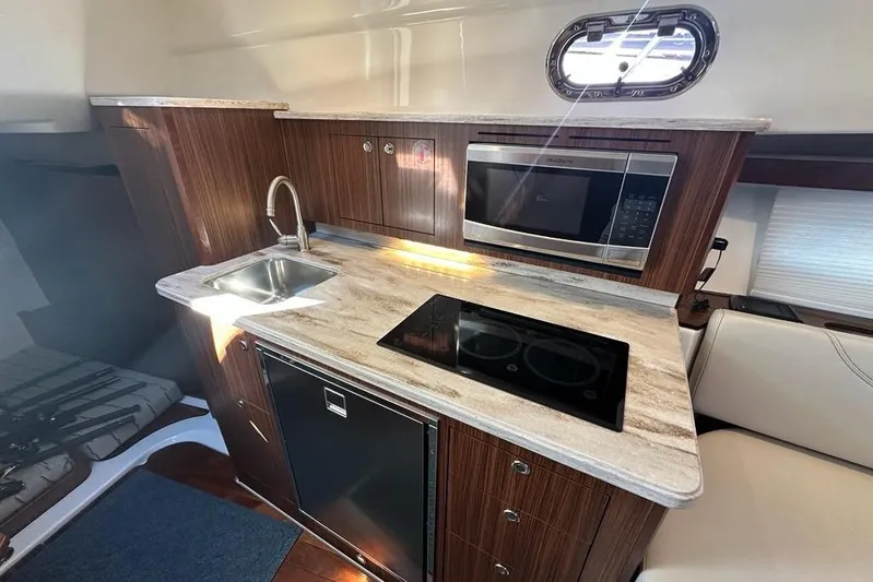Wave Paver Yacht Photos Pics Modern kitchen in 2020 Pursuit OS 355 Offshore boat with sink, stove, and microwave.