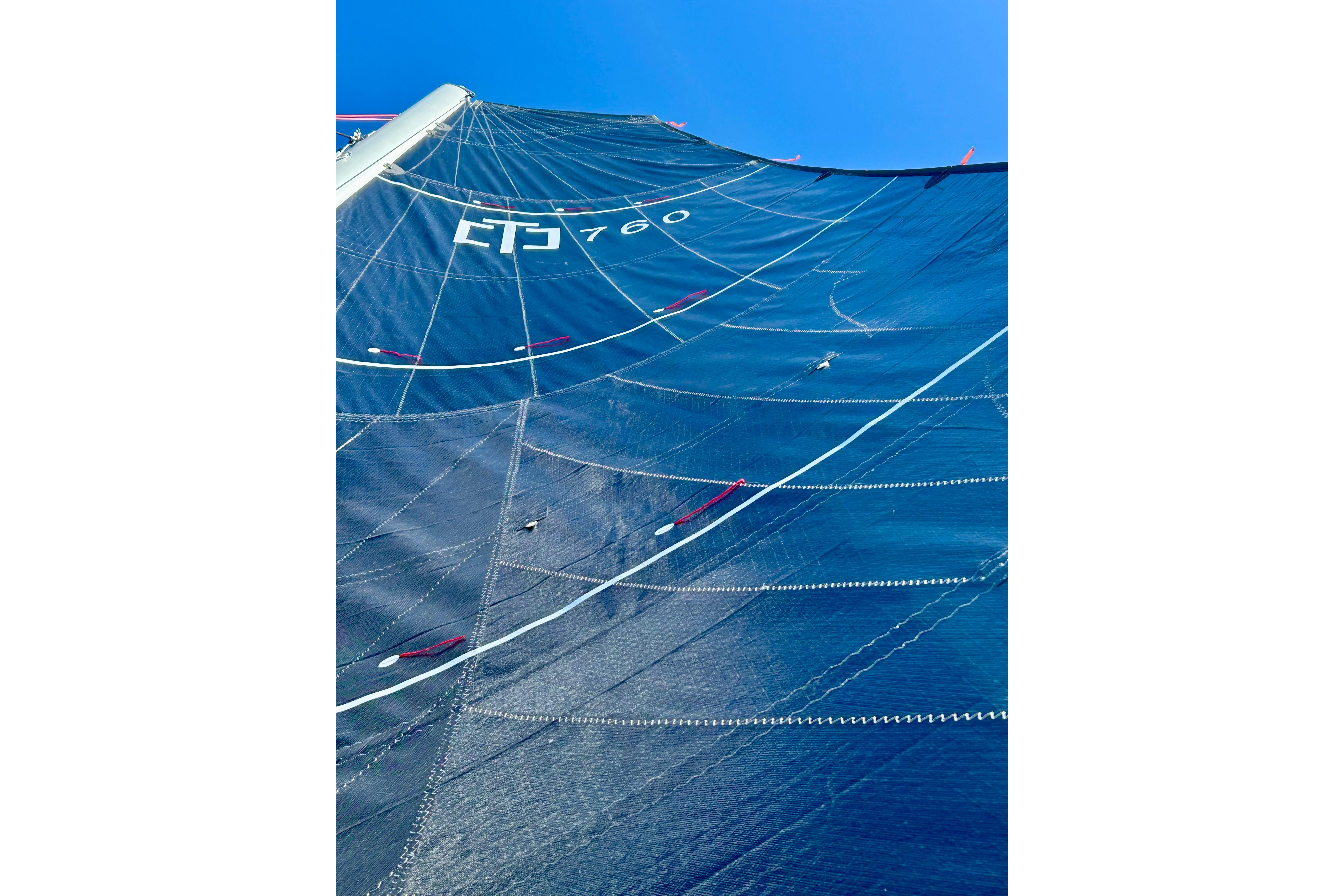 Sail of Corsair 760, 2025 model, against a clear blue sky.