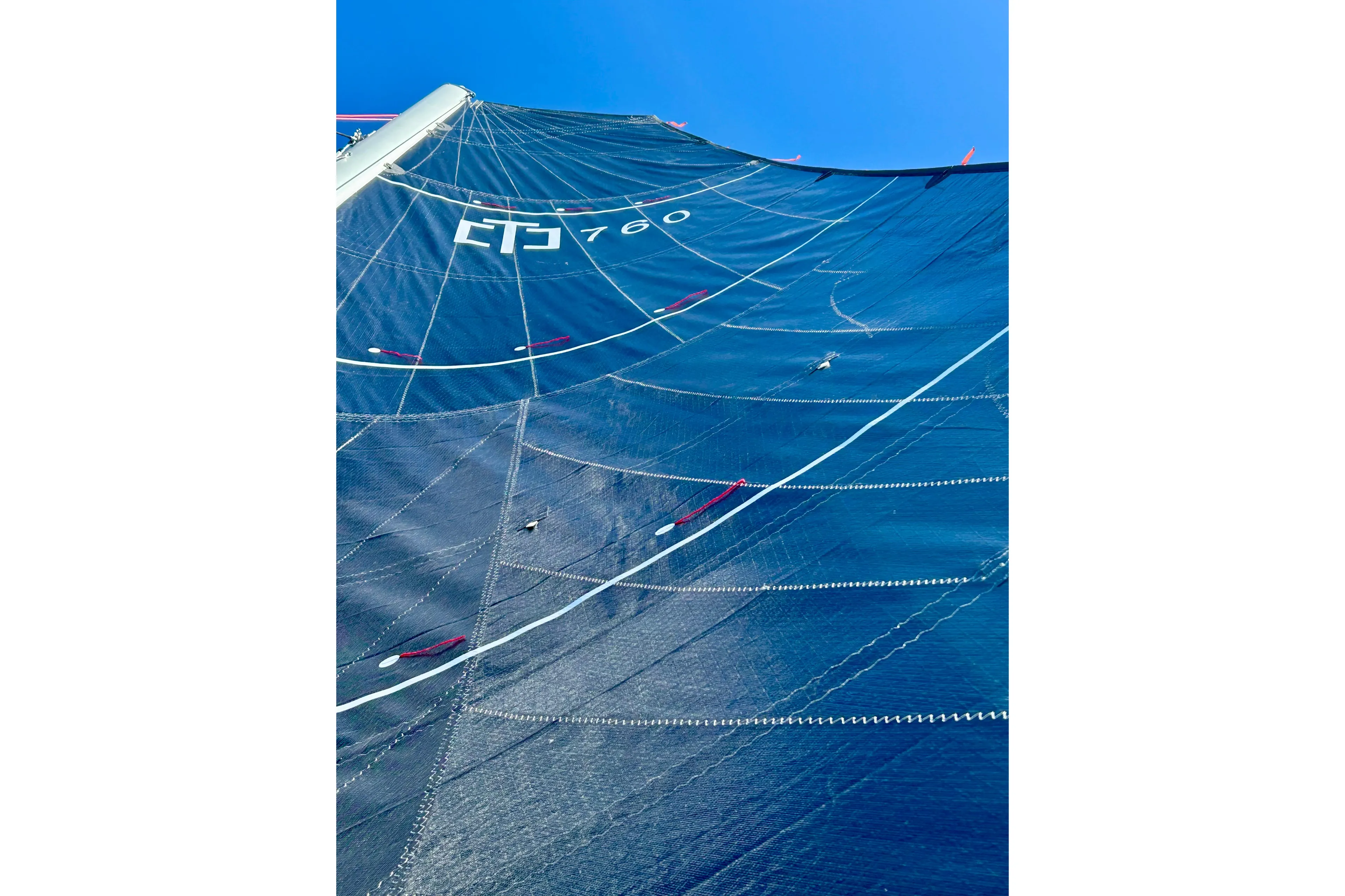 Sail of Corsair 760, 2025 model, against a clear blue sky.