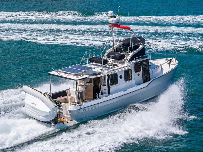 Salty Bliss Yacht Photos Pics 2021 Ranger Tugs R-31 CB cruising on blue ocean waters.
