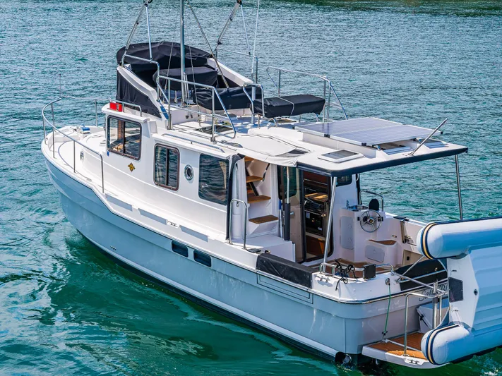 Salty Bliss Yacht Photos Pics 2021 Ranger Tugs R-31 CB boat on water, featuring upper deck and solar panels.