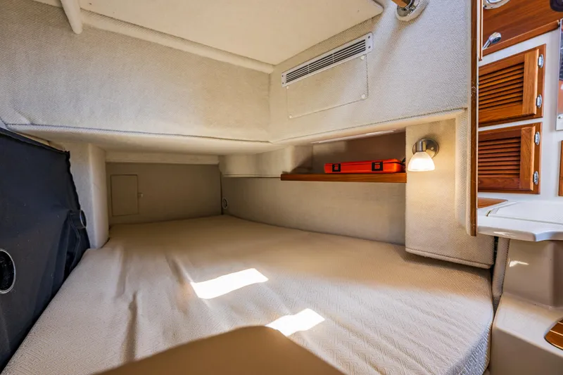 Salty Bliss Yacht Photos Pics 2021 Ranger Tugs R-31 CB cabin interior with bed, storage, and lighting.