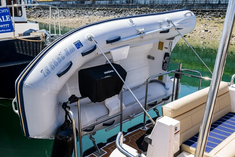 Salty Bliss Yacht Photos Pics 2021 Ranger Tugs R-31 CB with inflatable dinghy on deck, docked by the water.