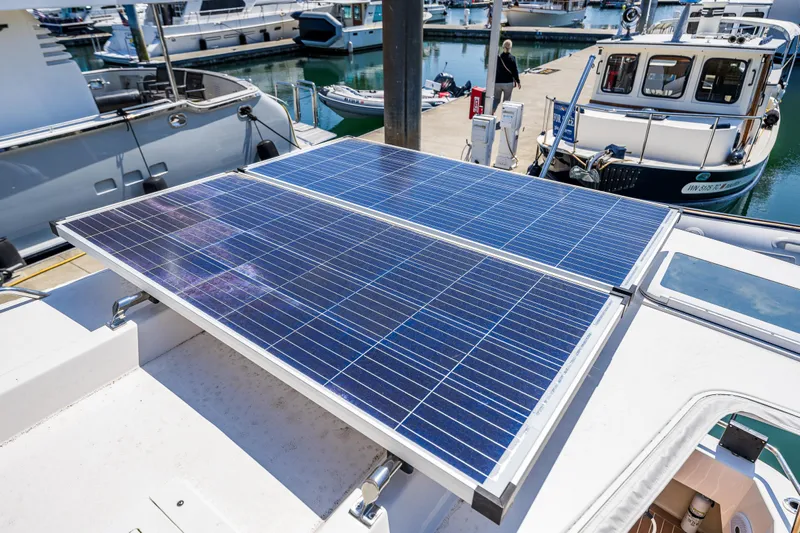 Salty Bliss Yacht Photos Pics Solar panels on a 2021 Ranger Tugs R-31 CB boat docked at a marina.