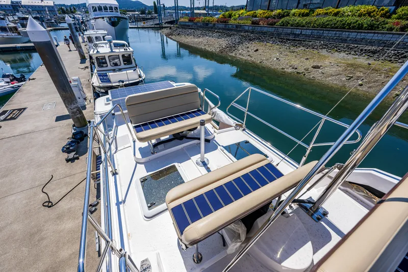 Salty Bliss Yacht Photos Pics 2021 Ranger Tugs R-31 CB docked, featuring spacious deck seating and scenic marina view.