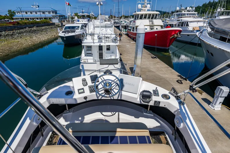 Salty Bliss Yacht Photos Pics 2021 Ranger Tugs R-31 CB at marina, surrounded by boats, clear sky.