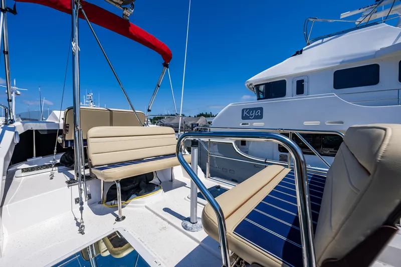 Salty Bliss Yacht Photos Pics 2021 Ranger Tugs R-31 CB boat deck with seating, blue sky background.
