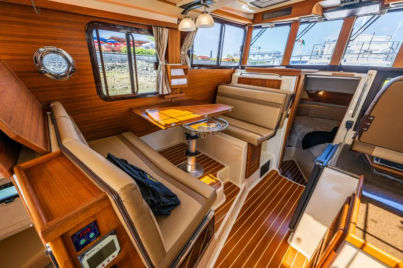 Salty Bliss Yacht Photos Pics Luxurious interior of 2021 Ranger Tugs R-31 CB with wood finish and comfortable seating.