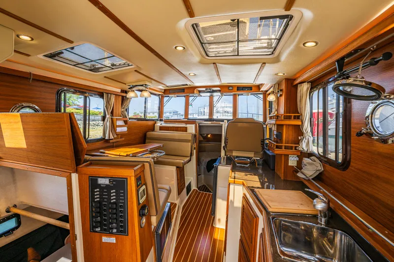 Salty Bliss Yacht Photos Pics Interior of 2021 Ranger Tugs R-31 CB, featuring wood finishes and modern amenities.