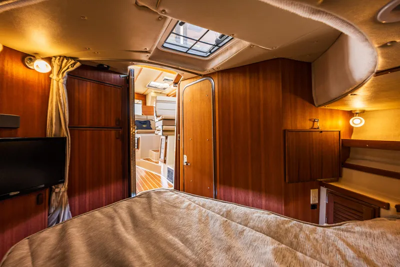 Salty Bliss Yacht Photos Pics 2021 Ranger Tugs R-31 CB cabin interior with wood paneling and cozy lighting.